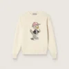 Goldfarbener Mädchenpullover aus weißem Baumwollgarn mit Maskottchen-Stickerei