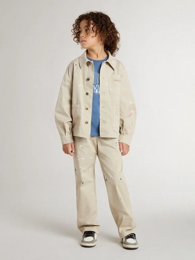 Beigefarbene Kinderjacke mit bunten Farbtupfern