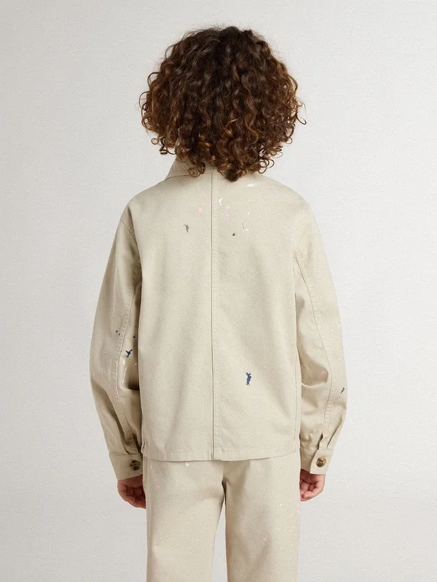 Beigefarbene Kinderjacke mit bunten Farbtupfern